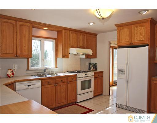 19 Timber Road Edison, NJ 08820 - Photo 4 of 25 a kitchen with stainless steel appliances granite countertop a sink stove and refrigerator