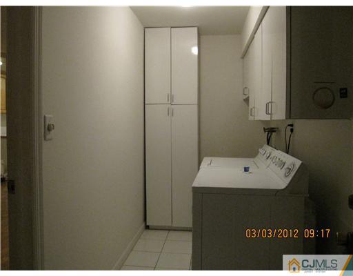 19 Timber Road Edison, NJ 08820 - Photo 6 of 25 a bathroom with a sink a mirror and a toilet
