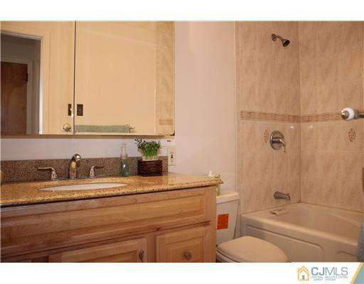 19 Timber Road Edison, NJ 08820 - Photo 7 of 25 a bathroom with a sink and a mirror
