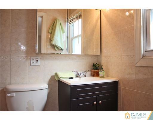 19 Timber Road Edison, NJ 08820 - Photo 8 of 25 a bathroom with a sink vanity and a mirror