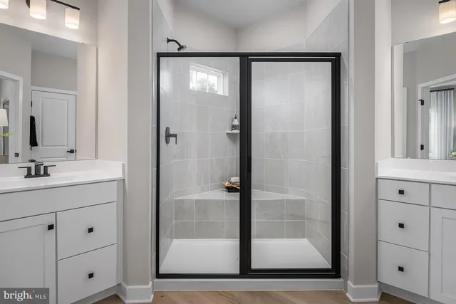 a bathroom with a shower sink and mirror