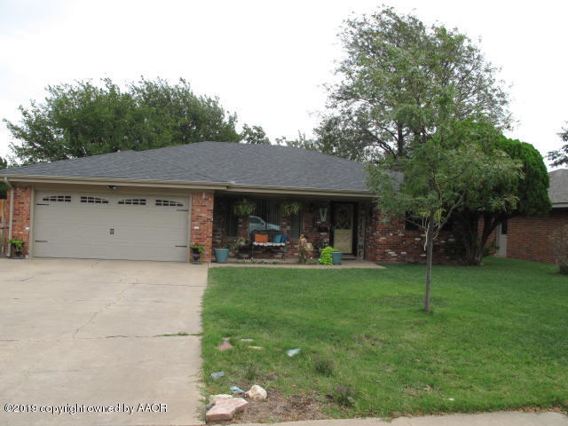 3305 Bedford Road Amarillo, TX 79106 - Photo 1 of 21 a front view of a house with a garden and trees