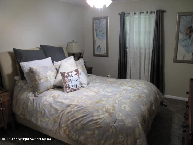3305 Bedford Road Amarillo, TX 79106 - Photo 15 of 21 a large bed sitting in a bedroom next to a window
