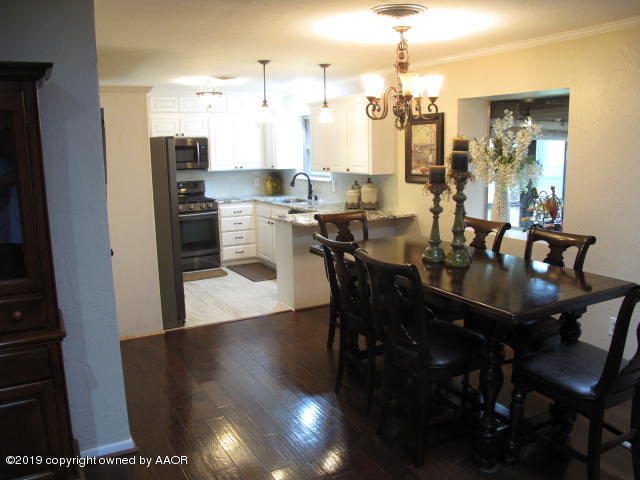 3305 Bedford Road Amarillo, TX 79106 - Photo 5 of 21 a view of a dining room and livingroom with furniture wooden floor a chandelier
