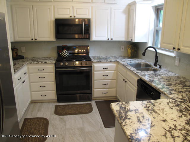 3305 Bedford Road Amarillo, TX 79106 - Photo 7 of 21 a kitchen with a stove and a granite counter tops