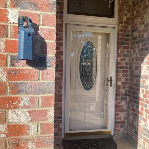 a view of a door of a house with a door and a wooden bench