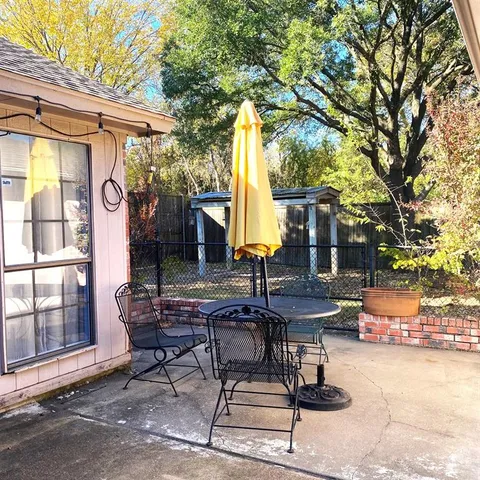 a view of a chairs and table in backyard of the house