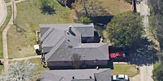an aerial view of a house with a yard