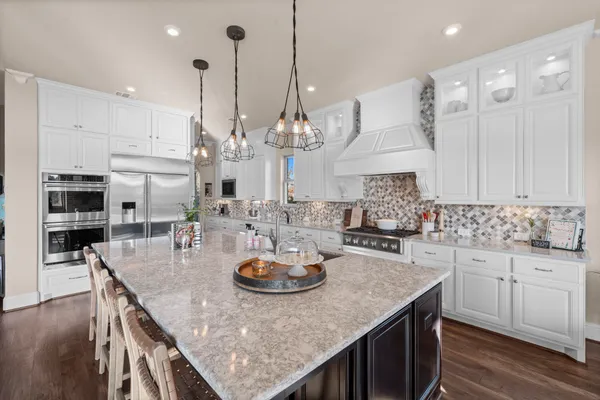 a kitchen with sink a microwave and cabinets