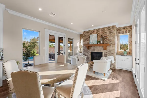 a living room with furniture a fireplace and a table