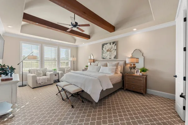 a bedroom with a bed couch and window