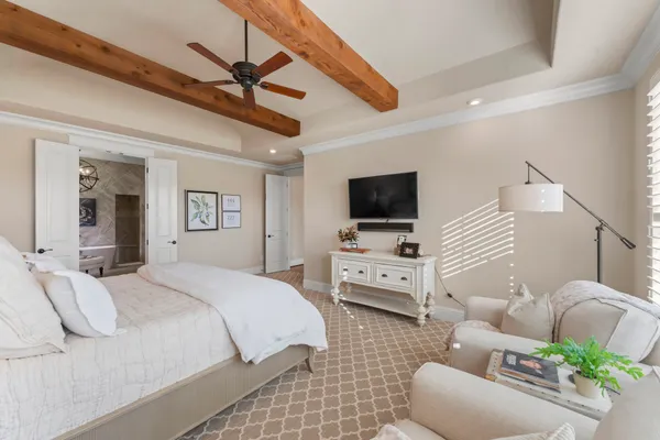 a bedroom with furniture and a flat screen tv