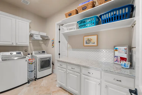 a kitchen with stainless steel appliances granite countertop a stove and a white cabinets