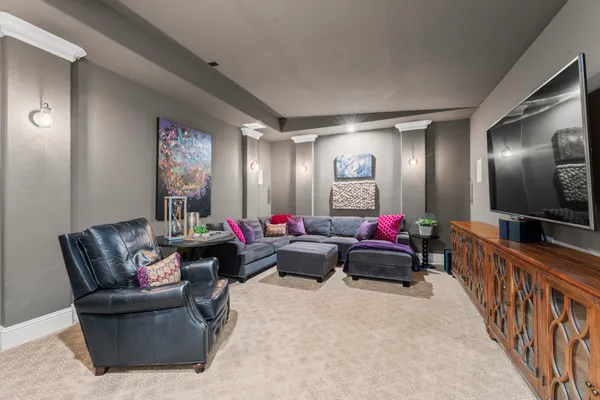 a living room with furniture and a chandelier