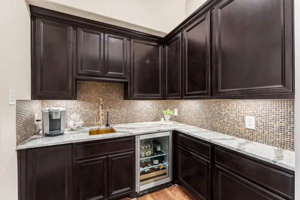 a bedroom with a bed a dresser and windows