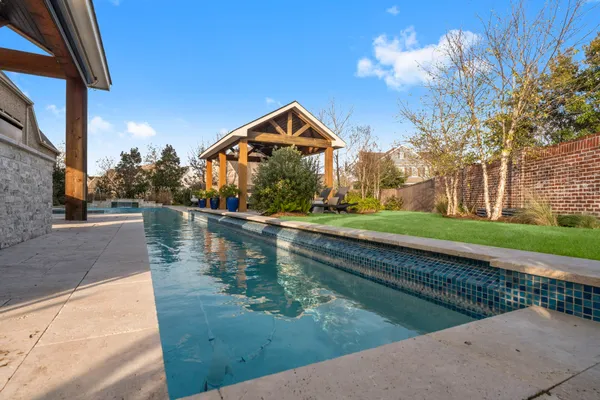 a backyard of a house with barbeque oven table and chairs