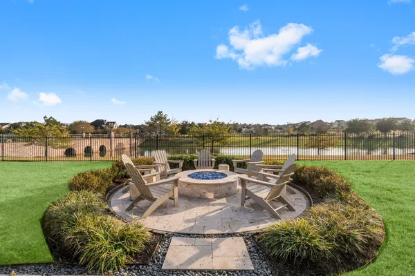 a view of a swimming pool and lounge chairs in back yard