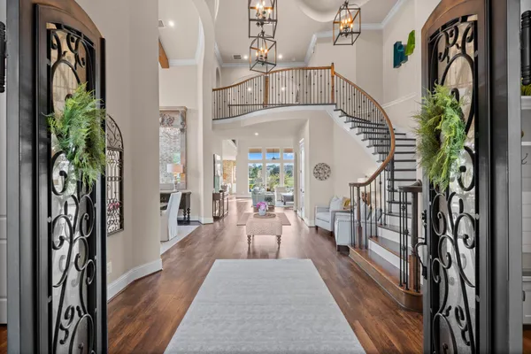 a view of entryway and hall with wooden floor
