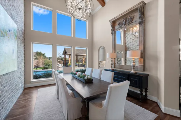 a dining room with furniture and a floor to ceiling window