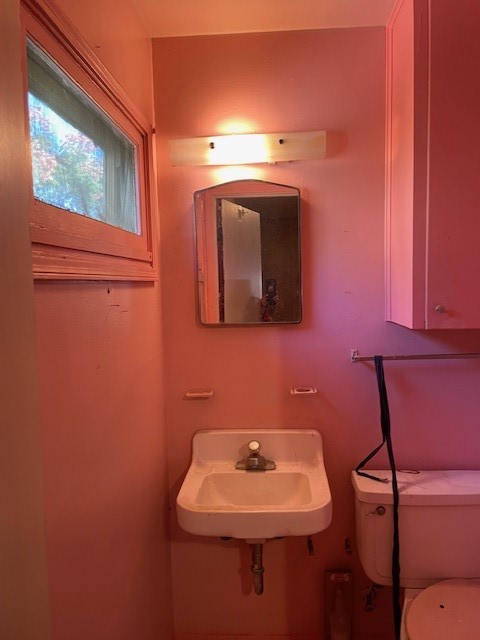 3530 Carrolleton Street Corpus Christi, TX 78411 - Photo 12 of 16 a bathroom with a toilet sink and mirror