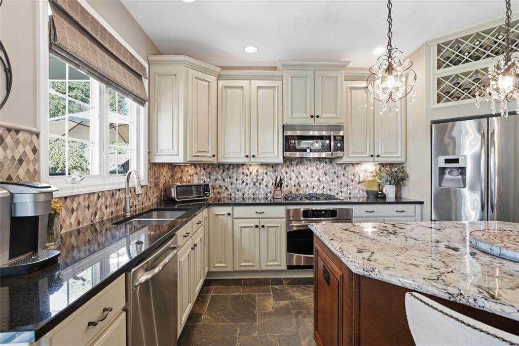 4502 Senate Court Valencia, PA 16059 - Photo 23 of 49 a kitchen with stainless steel appliances granite countertop a sink stove and refrigerator