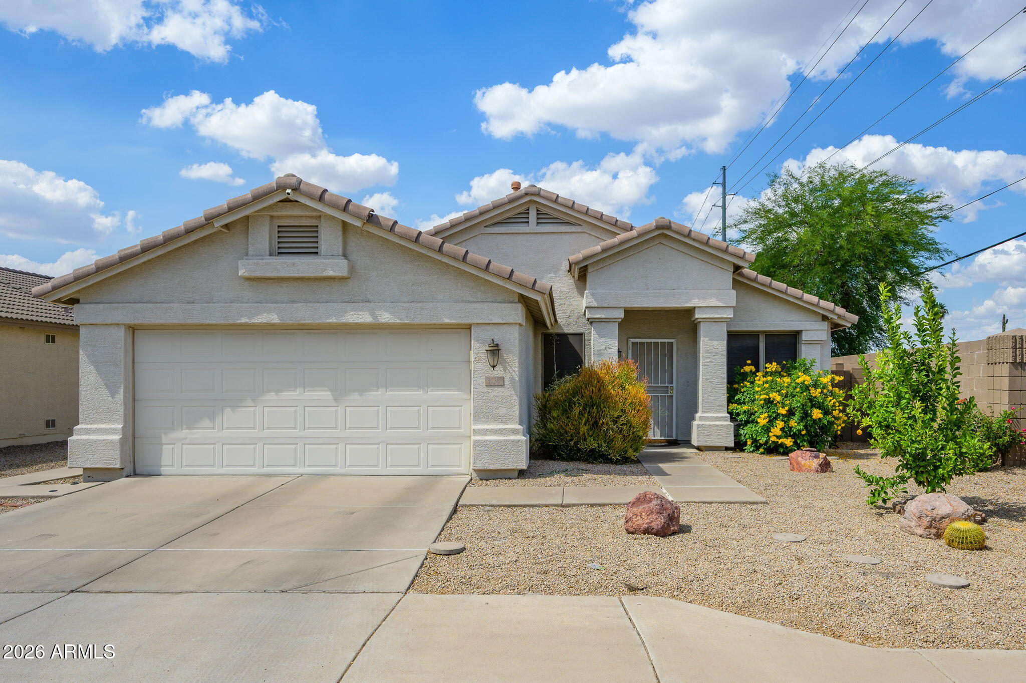3136 East Roveen Avenue Phoenix, AZ 85032 - Photo 3 of 38 a front view of a house with garden
