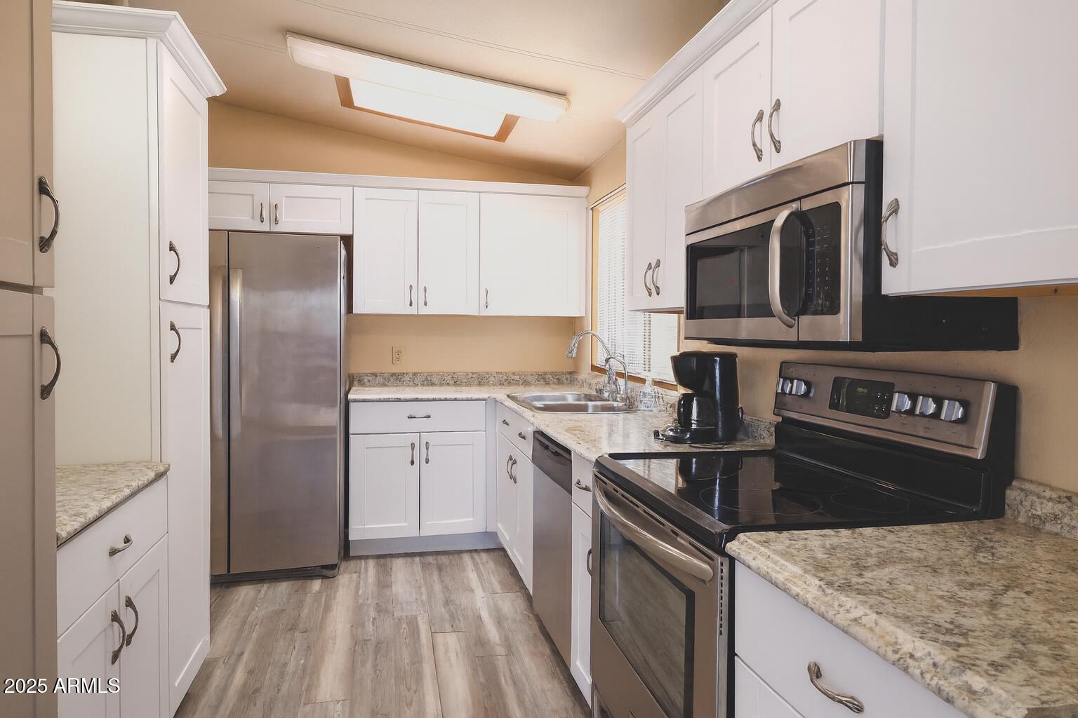 8600 East Broadway Road, Unit 55 Mesa, AZ 85208 - Photo 1 of 14 a kitchen with a stove microwave and refrigerator