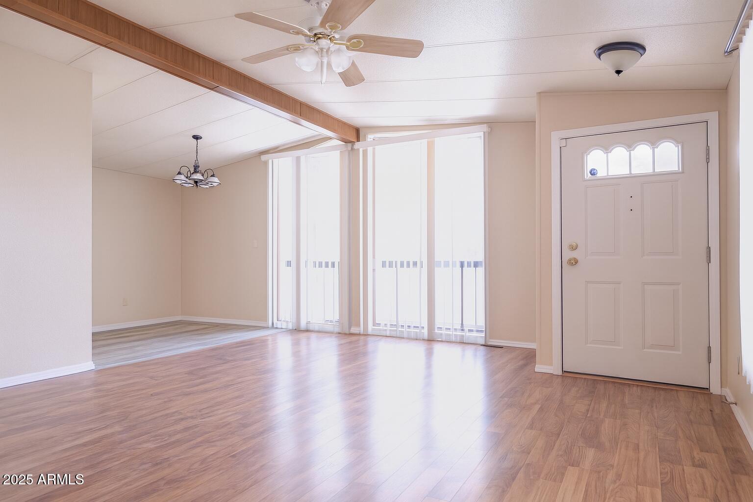 8600 East Broadway Road, Unit 55 Mesa, AZ 85208 - Photo 5 of 14 an empty room with wooden floor fan and windows