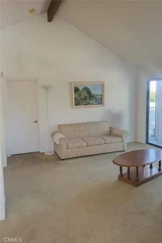 a view of an empty room with a fireplace and window