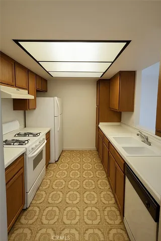 a kitchen with sink cabinets and stove top oven