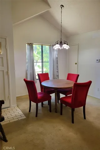 a dining room with furniture a chandelier and wooden floor