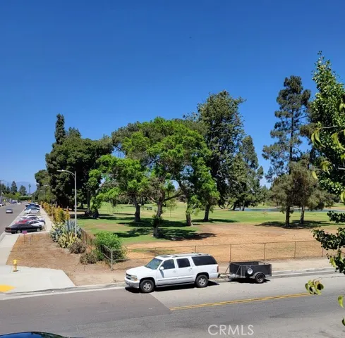 a view of a street with cars parked