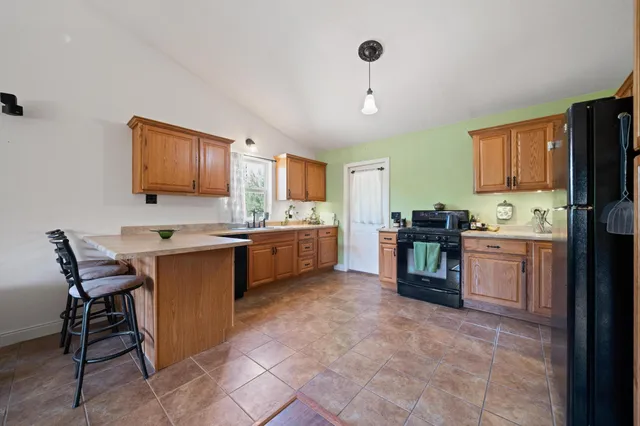 a kitchen with cabinets and chairs