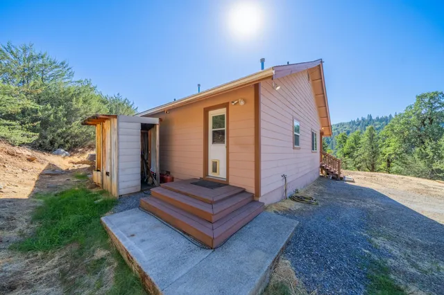 a wooden bench sitting in front of a house
