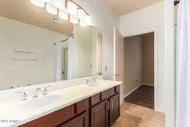 a bathroom with a sink double vanity and a mirror