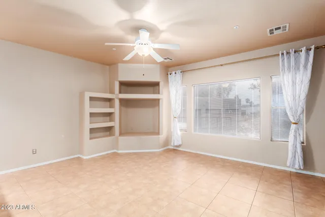 a view of kitchen with refrigerator and microwave