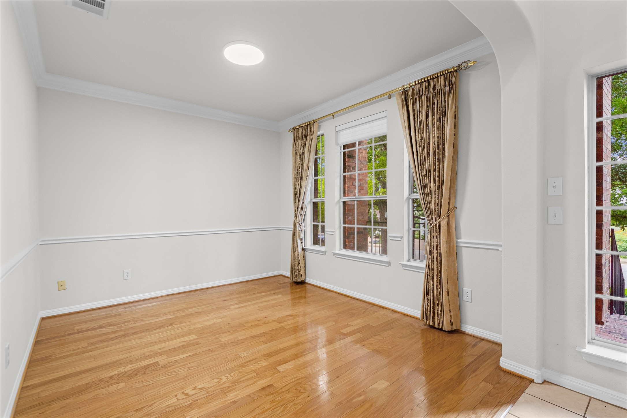 10700 Pointe View Drive Austin, TX 78738 - Photo 7 of 35 Hardwood floors and natural light illuminate this adaptable room, ready for your personalized touch.