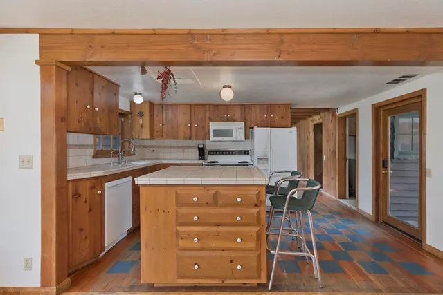 a kitchen that has a cabinets and a table in it