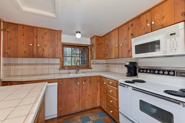a kitchen with a sink stove and microwave