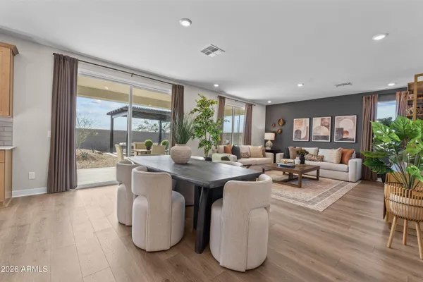 a living room with fireplace furniture and a large window