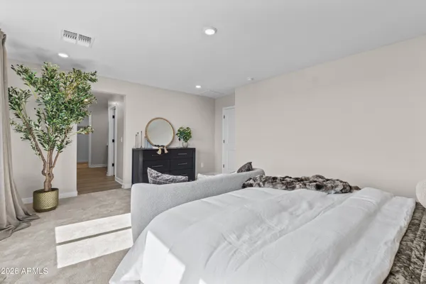 a bedroom with bed and a potted plant