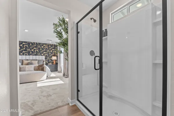 a bathroom with a glass shower door