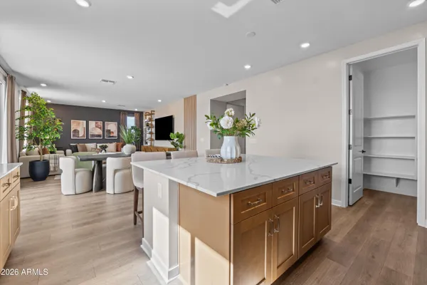 a kitchen with kitchen island granite countertop a sink counter top space and living room view