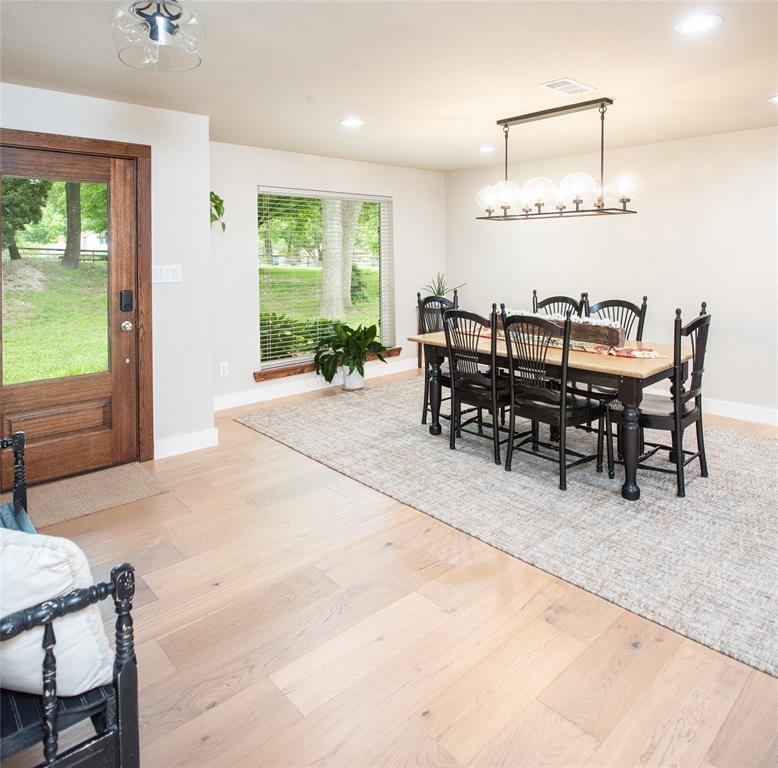 1451 Meandro Ria Lane Fairview, TX 75069 - Photo 6 of 38 a dining room with furniture and a large window