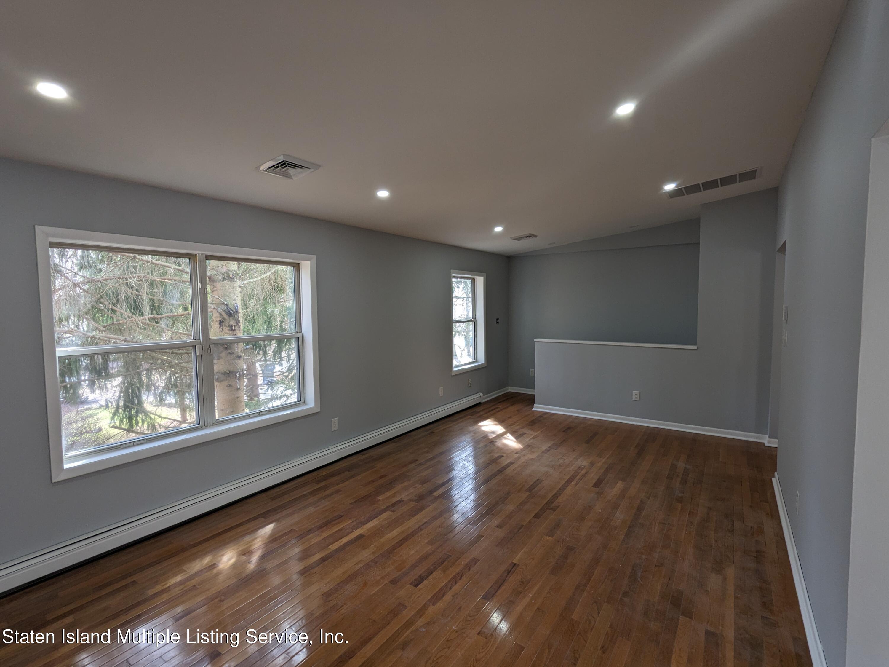 7609 Sawmill Road Pocono Lake, PA 18347 - Photo 19 of 47 a view of an empty room with wooden floor and a window