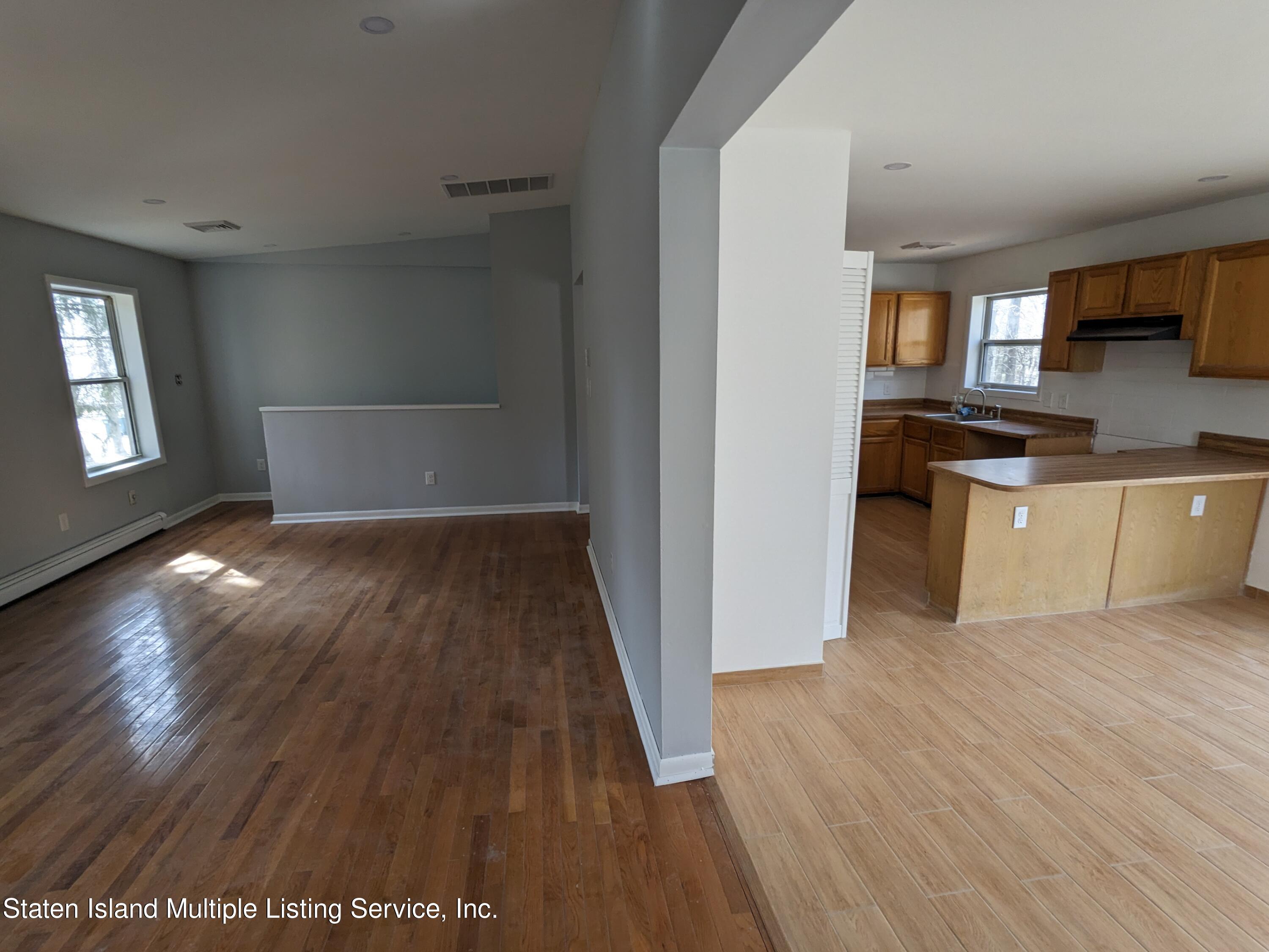 7609 Sawmill Road Pocono Lake, PA 18347 - Photo 20 of 47 an empty room with wooden floor and windows