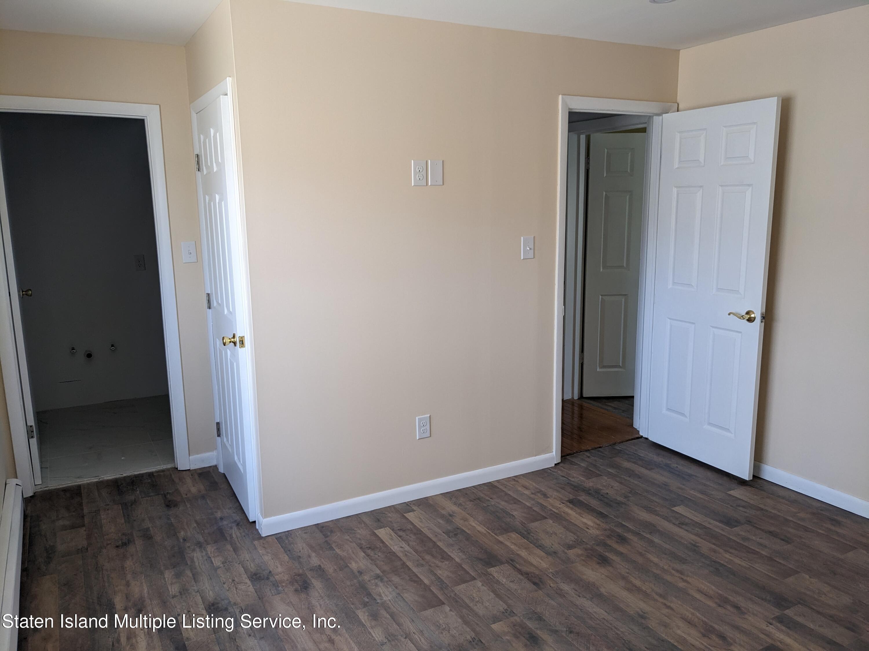 7609 Sawmill Road Pocono Lake, PA 18347 - Photo 24 of 47 an empty room with wooden floor and entrance