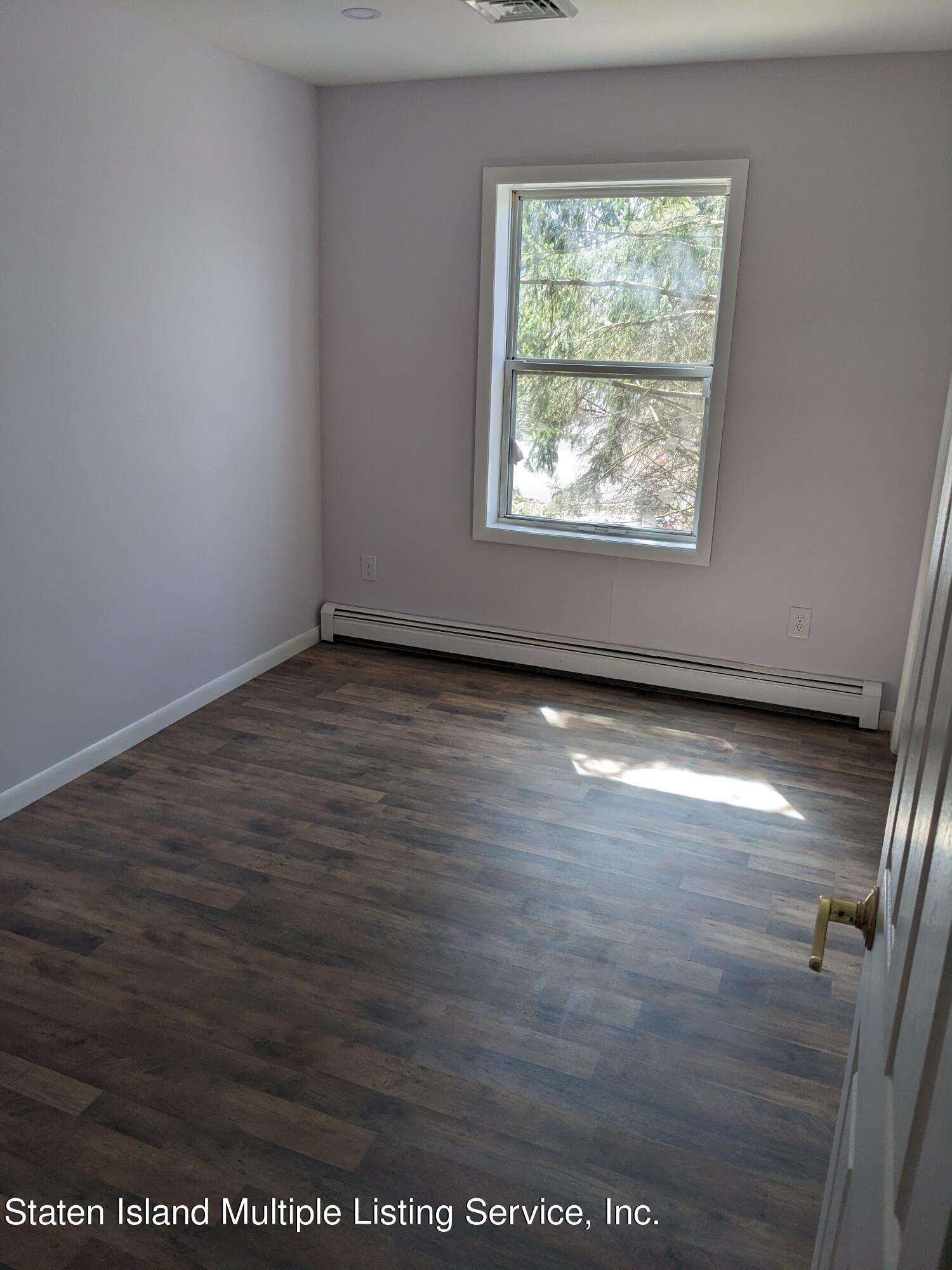 7609 Sawmill Road Pocono Lake, PA 18347 - Photo 31 of 47 an empty room with wooden floor and windows