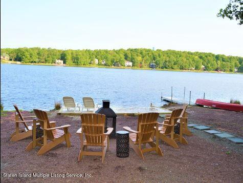 7609 Sawmill Road Pocono Lake, PA 18347 - Photo 37 of 47 a view of a lake with table and chairs