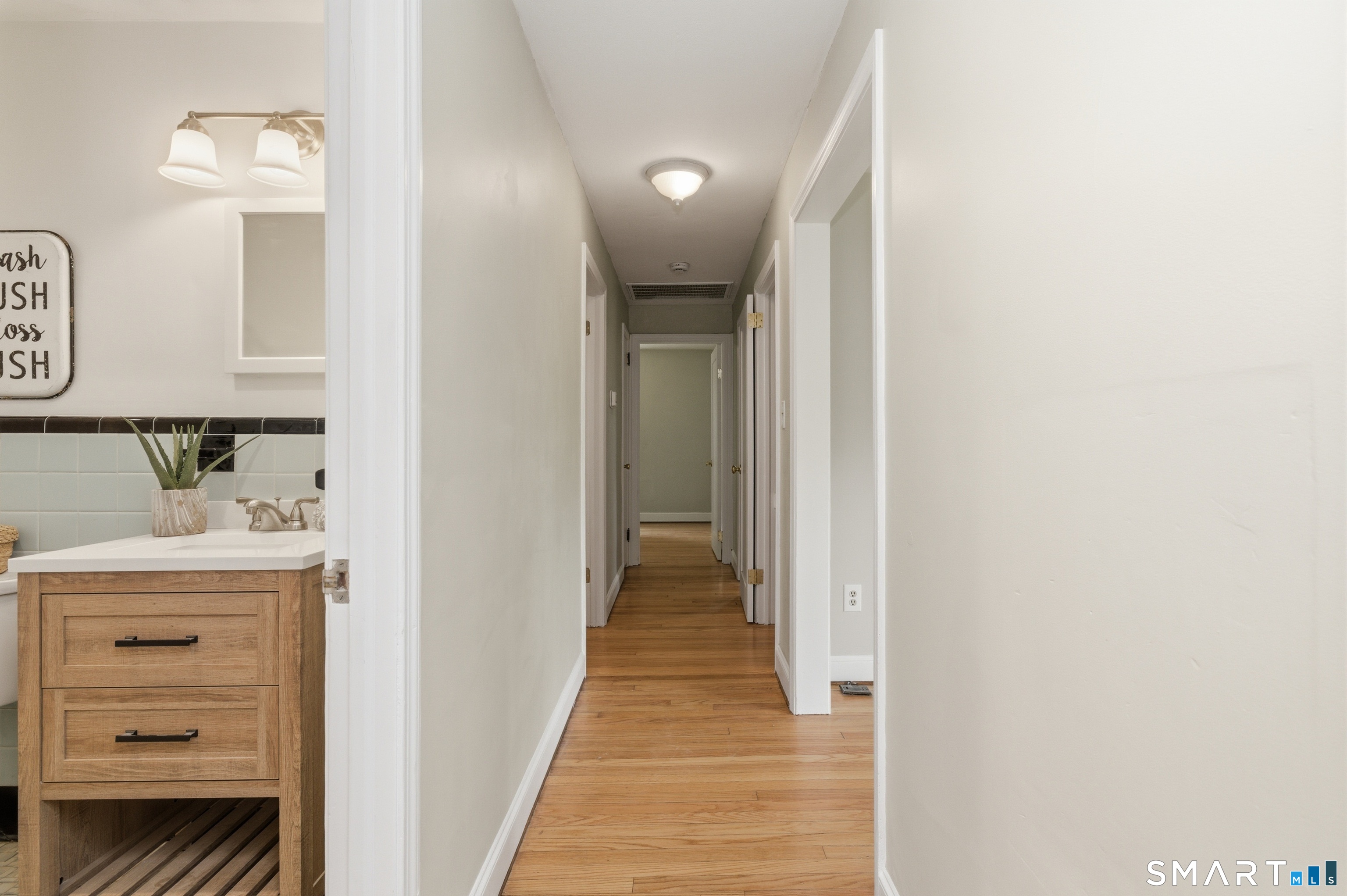 149 Mill Street Wethersfield, CT 06109 - Photo 17 of 29 a view of a hallway with closet and wooden floor